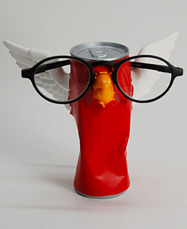 TIN WINGS 
Glasses holder tabletop. Crushed can with beak and wings.
Eyeglasses holder in hand painted resin. Antartidee